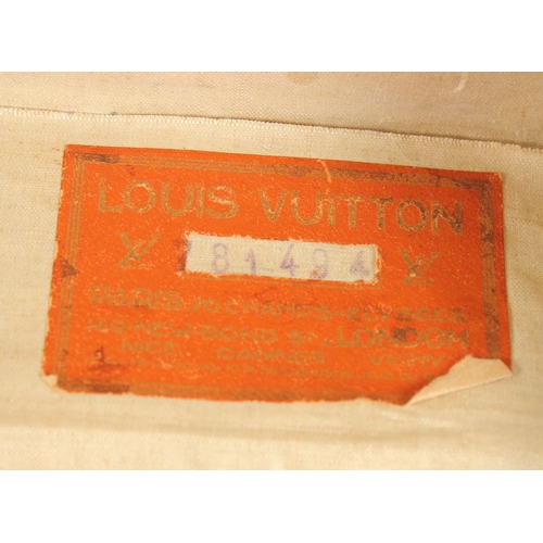 1514 - A LOUIS VUITTON SUITCASE. No. 81494, with Louis Vuitton label. Related label, bought from SAKS & Co.... 