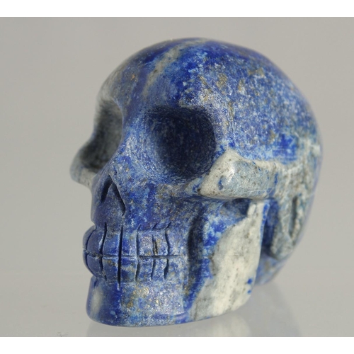 1538 - A CARVED LAPIS SKULL 2ins high.