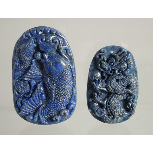 1540 - TWO CARVED LAPIS PENDANTS.