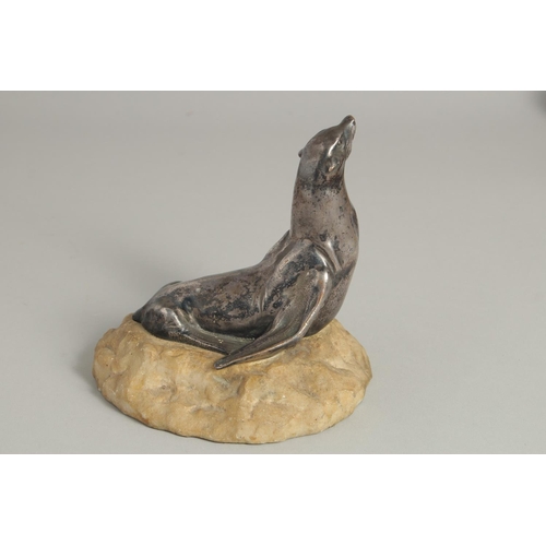 1546 - MOREAUX. A MODEL OF A SEA LION on a stone base. Signed. 5ins long.