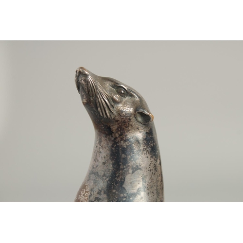 1546 - MOREAUX. A MODEL OF A SEA LION on a stone base. Signed. 5ins long.