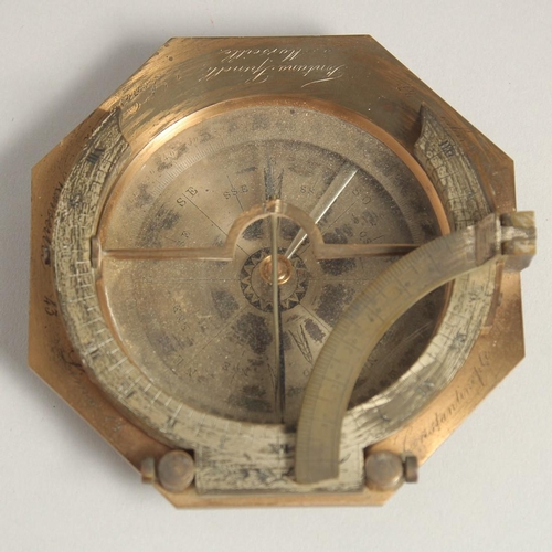 1548 - A GEORGIAN OCTAGONAL BRASS TRAVELLING COMPASS with silvered dial. Made in Paris. 3.75ins in a leathe... 