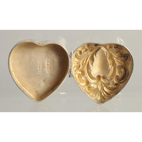 1564 - A SMALL FRENCH OVAL SILVER BOX AND COVER 1.25ins and a heart shaped box. (2).