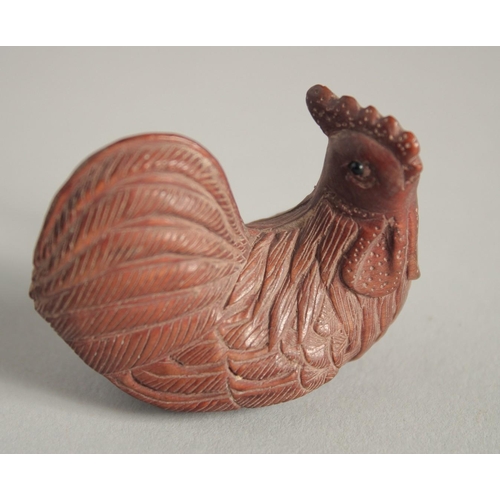 1573 - A WOODEN NETSUKE OF A CHICKEN. Signed, 2ins long.