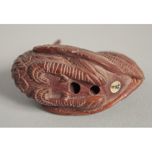 1573 - A WOODEN NETSUKE OF A CHICKEN. Signed, 2ins long.