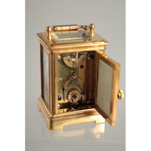 1605 - A MINIATURE BRASS CARRIAGE CLOCK 2ins high.