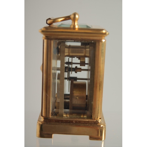 1611 - A MINIATURE GILT FACED CARRIAGE CLOCK. 2ins.