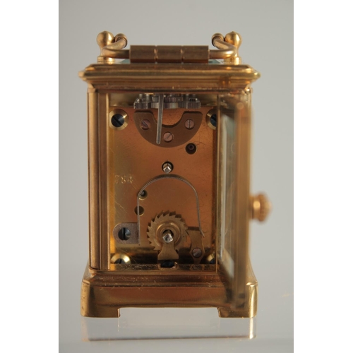 1611 - A MINIATURE GILT FACED CARRIAGE CLOCK. 2ins.