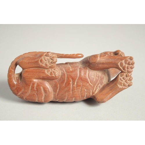 1623 - A CARVED WOOD TIGER. 5.5ins long.