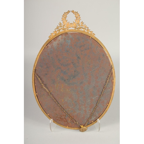 1650 - A LARGE EMPIRE GILDED OVAL PHOTOGRAPH FRAME. 14ins x 11ins.