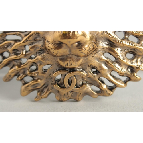 1674 - A CHANEL GILT COSTUME LION HEAD BROOCH with white label and Chanel box.