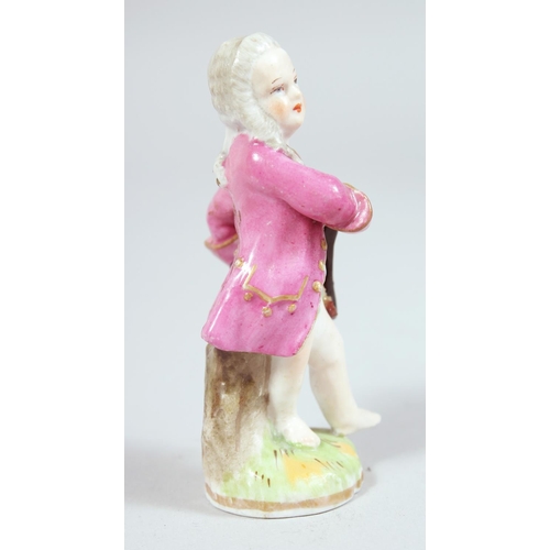 1694 - A SMALL BERLIN PORCELAIN FIGURE on a box. Sceptre mark in blue, 3.5ins high.