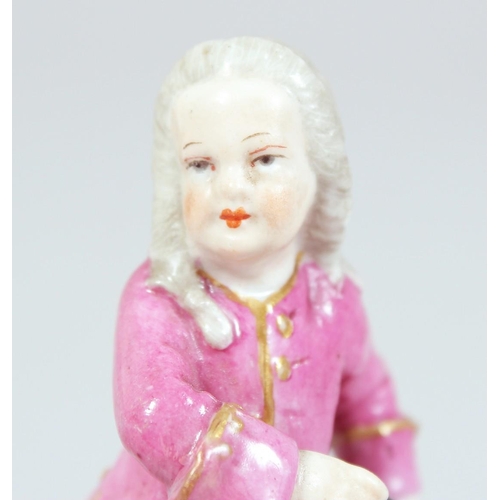 1694 - A SMALL BERLIN PORCELAIN FIGURE on a box. Sceptre mark in blue, 3.5ins high.