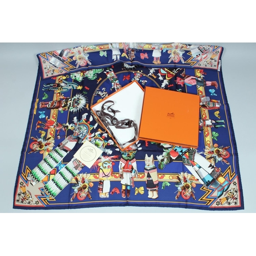 1698 - AN HERMES SILK SCARF, puppet and toy on a blue ground. 34ins x 334ins in a Hermes box.