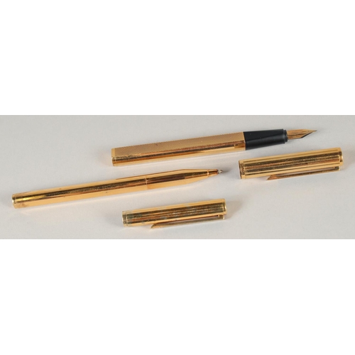 1702 - TWO DUNHILL GILT PENS, a ballpoint and fountain pen.