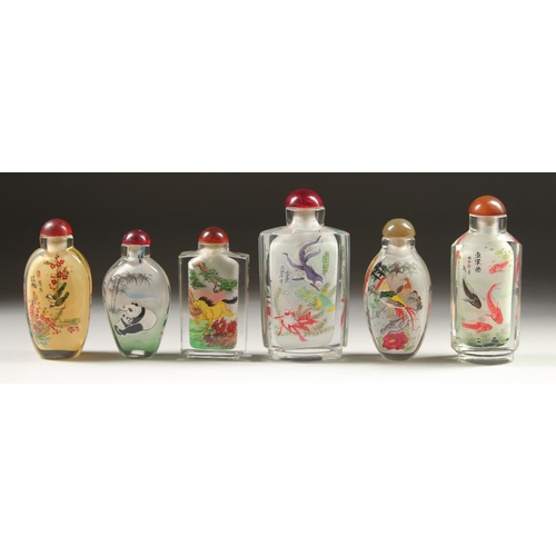 1709 - A COLLECTION OF SIX CHINESE SCENT BOTTLES AND STOPPERS painted with fish, pandas, birds, houses, and... 