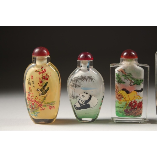 1709 - A COLLECTION OF SIX CHINESE SCENT BOTTLES AND STOPPERS painted with fish, pandas, birds, houses, and... 