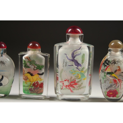 1709 - A COLLECTION OF SIX CHINESE SCENT BOTTLES AND STOPPERS painted with fish, pandas, birds, houses, and... 