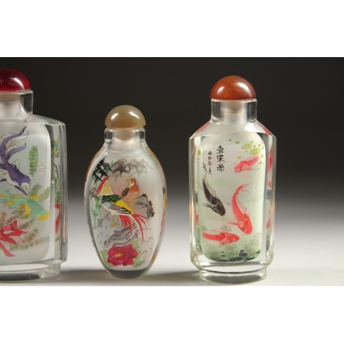 1709 - A COLLECTION OF SIX CHINESE SCENT BOTTLES AND STOPPERS painted with fish, pandas, birds, houses, and... 