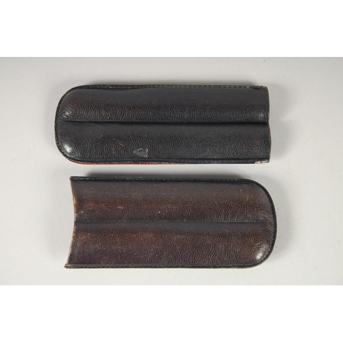 1712 - THREE LEATHER CIGAR CASES AND TWO CUTTERS (5).