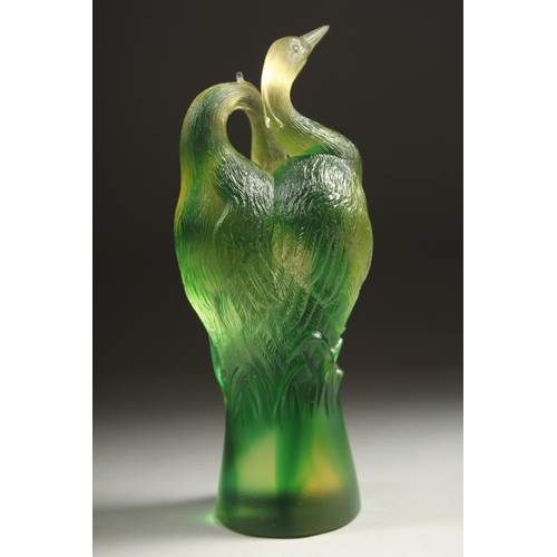 1713 - A GOOD PAIR OF TITTOT GREEN GLASS ENTWINED BIRDS. Signed 6.5ins high.