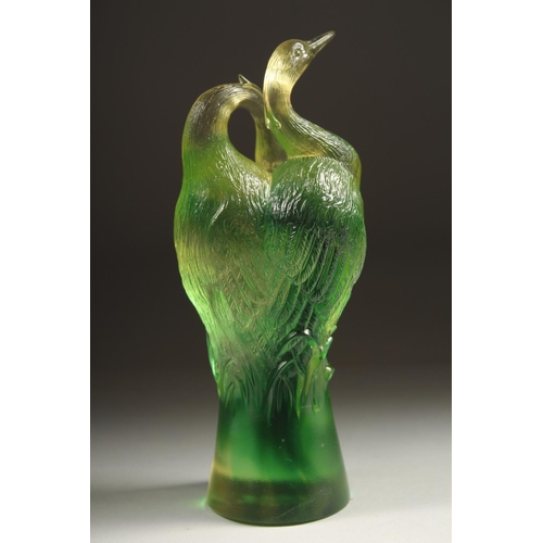 1713 - A GOOD PAIR OF TITTOT GREEN GLASS ENTWINED BIRDS. Signed 6.5ins high.