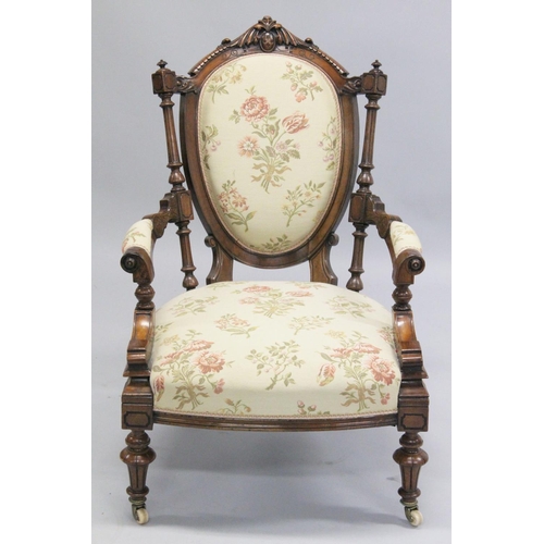 1001 - A GOOD VICTORIAN CARVED WALNUT NURSING AND MATCHING ARMCHAIR with padded back, arms and seat, suppor... 