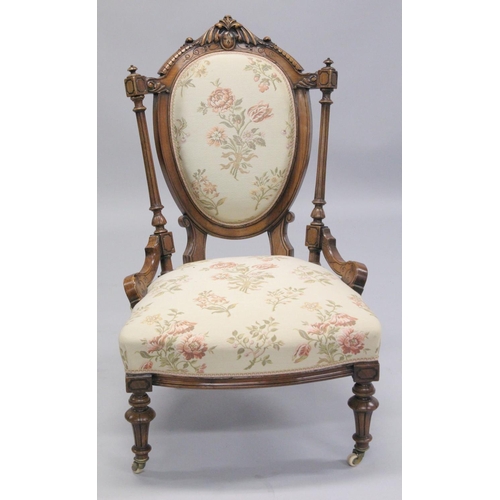 1001 - A GOOD VICTORIAN CARVED WALNUT NURSING AND MATCHING ARMCHAIR with padded back, arms and seat, suppor... 