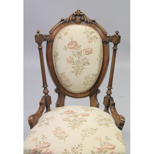 1001 - A GOOD VICTORIAN CARVED WALNUT NURSING AND MATCHING ARMCHAIR with padded back, arms and seat, suppor... 