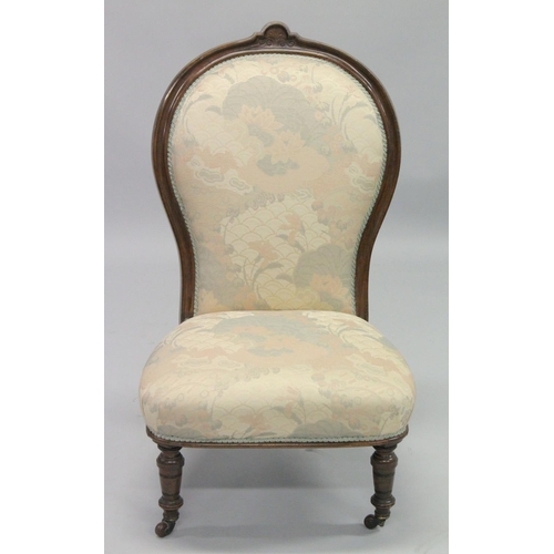 1002 - A VICTORIAN MAHOGANY FRAMED NURSING CHAIR with padded back and seat, on porcelain castors.