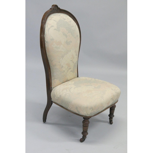 1002 - A VICTORIAN MAHOGANY FRAMED NURSING CHAIR with padded back and seat, on porcelain castors.