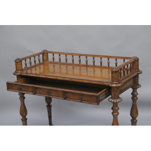 1009 - A 19TH CENTURY STYLE WALNUT WRITING TABLE with spindle back, sliding drawer with fall front, on turn... 