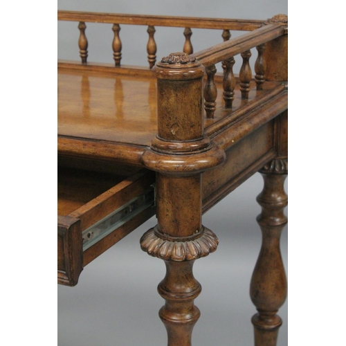 1009 - A 19TH CENTURY STYLE WALNUT WRITING TABLE with spindle back, sliding drawer with fall front, on turn... 