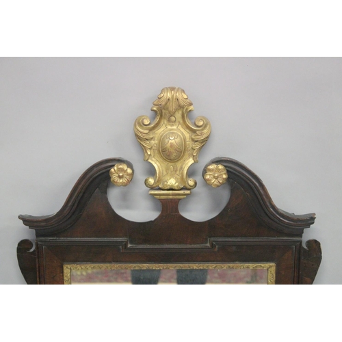 1010 - A GEORGE III MAHOGANY AND GILDED FRETWORK FRAMED WALL MIRROR, with swan neck pediment, curved and gi... 