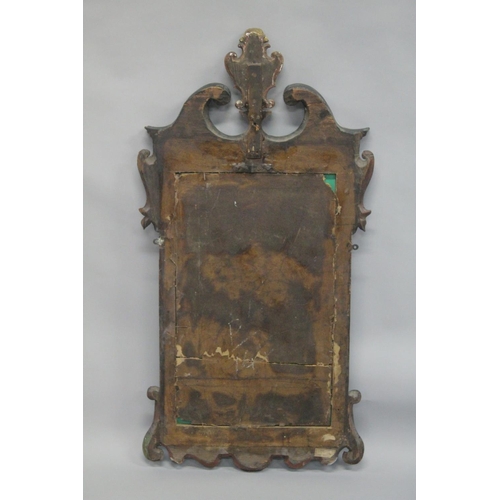 1010 - A GEORGE III MAHOGANY AND GILDED FRETWORK FRAMED WALL MIRROR, with swan neck pediment, curved and gi... 