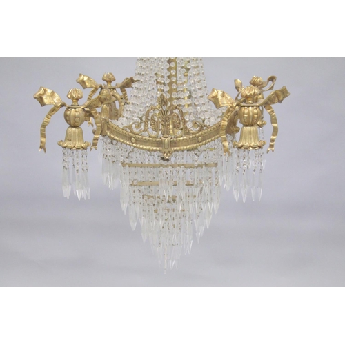 1037 - A GOOD GILT BRONZE AND CRYSTAL CHANDELIER with prism drops and cupids. 3ft long.