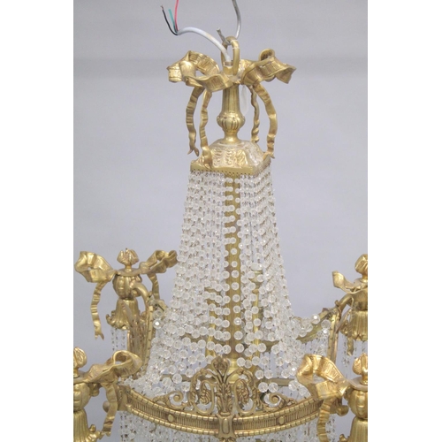 1037 - A GOOD GILT BRONZE AND CRYSTAL CHANDELIER with prism drops and cupids. 3ft long.