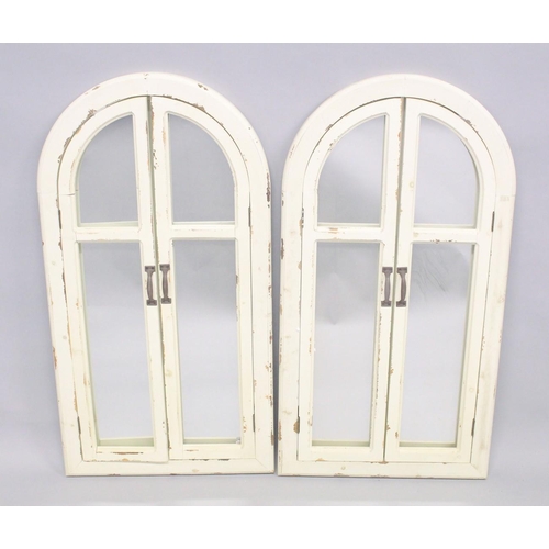 1039 - A PAIR OF WHITE ARCHED SHUTTER MIRRORS. 3ft 6ins x 1st 8ins.