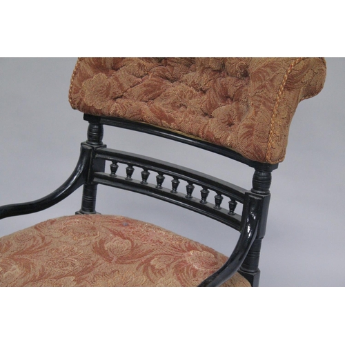 1045 - AN AESTHETIC MAHOGANY ARMCHAIR with black frame.