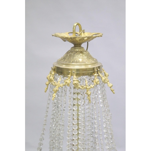 1049 - A LARGE ORMOLU AND CRYSTAL CIRCULAR CHANDELIER with four rows of prism drops, six triple pairs of cu... 