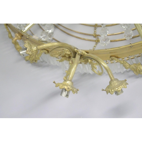 1049 - A LARGE ORMOLU AND CRYSTAL CIRCULAR CHANDELIER with four rows of prism drops, six triple pairs of cu... 