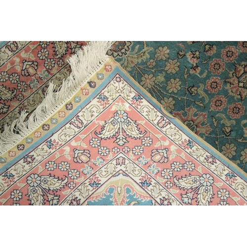 1058 - A GOOD SMALL SHIRVAN SILK RUG turquoise ground with floral decoration in a pink ground border.