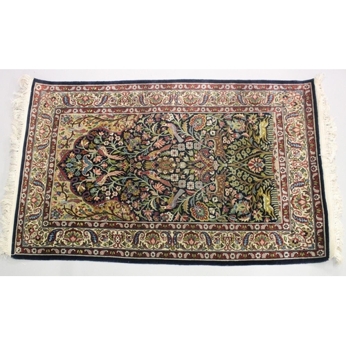 1059 - A GOOD SMALL PERSIAN RUG SHIRVAN OR ISFAHAN, dark blue ground with deer and exotic birds amongst fol... 