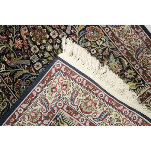 1059 - A GOOD SMALL PERSIAN RUG SHIRVAN OR ISFAHAN, dark blue ground with deer and exotic birds amongst fol... 