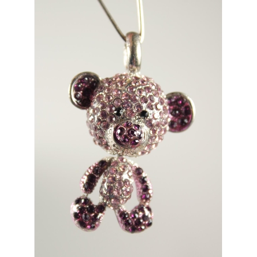 1725 - A SILVER TEDDY BEAR PENDANT set with pink stones.