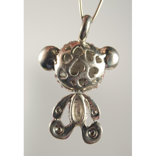 1725 - A SILVER TEDDY BEAR PENDANT set with pink stones.