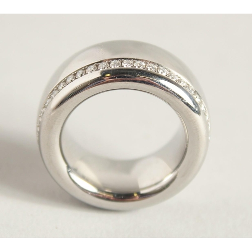 1726 - A DESIGNER TITANIUM RING set with diamonds. 27.8gms.