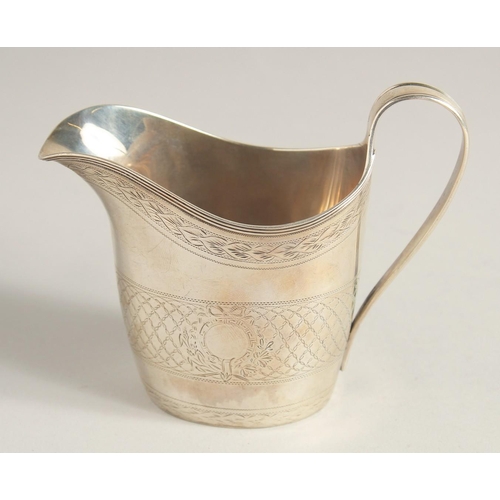 1881 - A GEORGE III SILVER CREAM JUG with reeded edge and engraved body. London 1795.