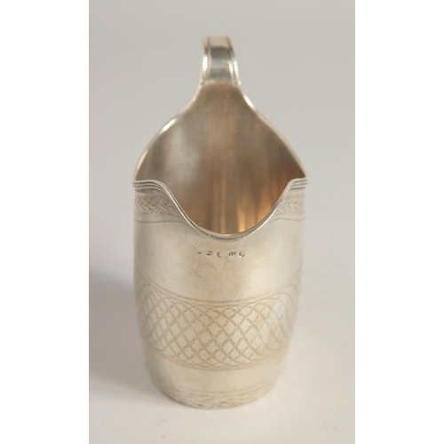 1881 - A GEORGE III SILVER CREAM JUG with reeded edge and engraved body. London 1795.