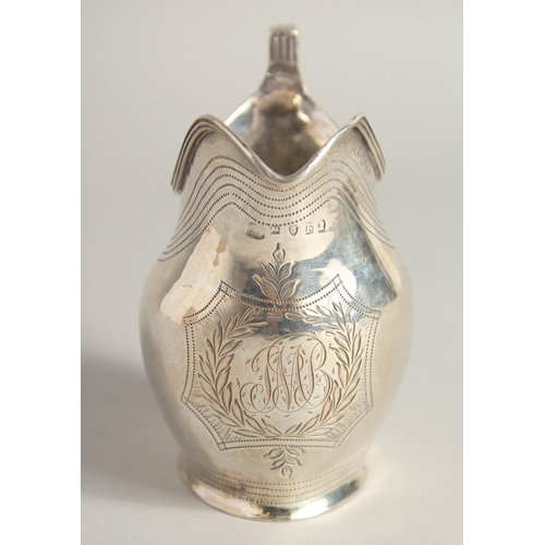 1882 - A GEORGE III SILVER CREAM JUG with reeded edge and engraved crest. London 1801 maker A & G  BURROWS.... 